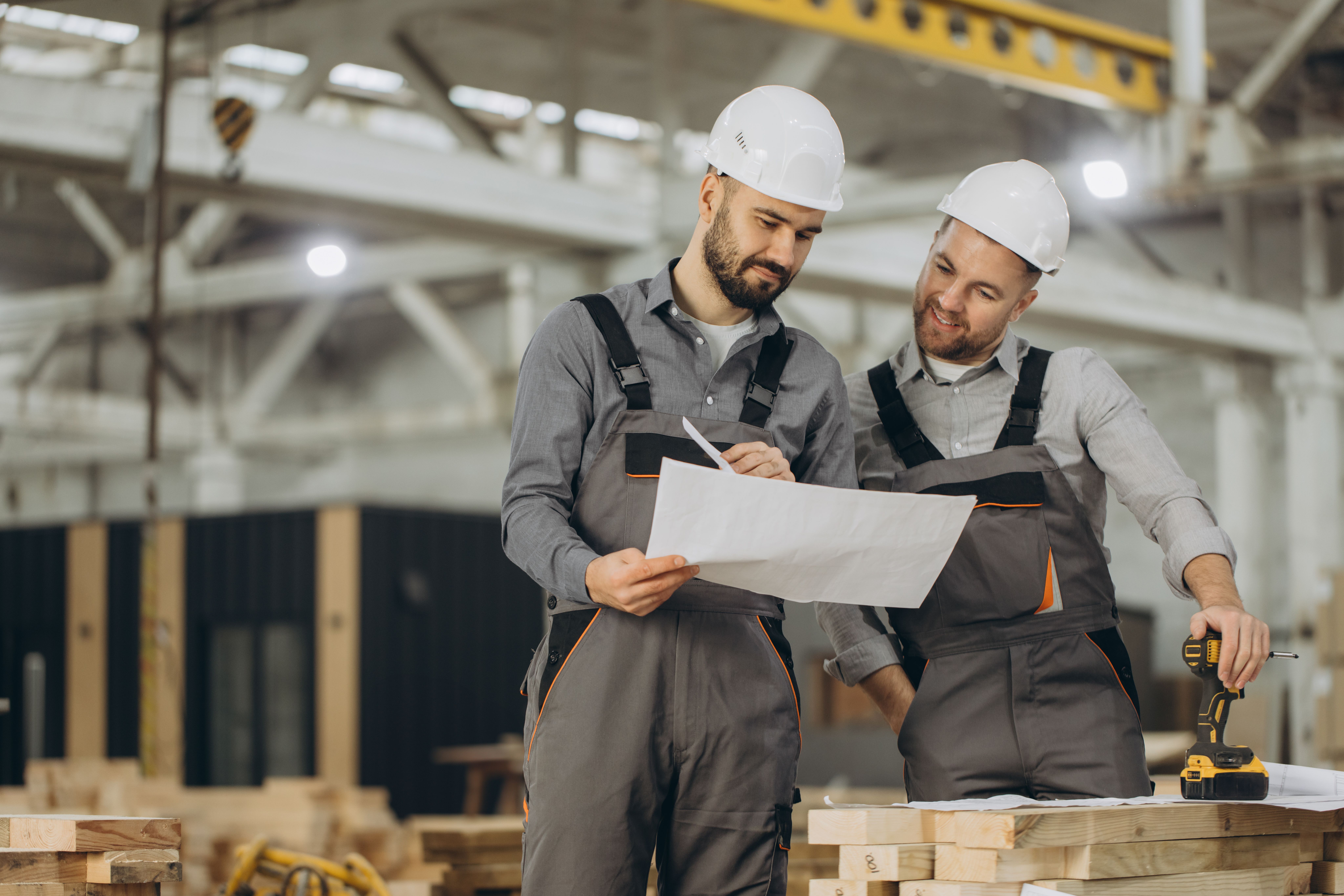 construction-workers-discussing-blueprint-modular-building-factory (1).jpg